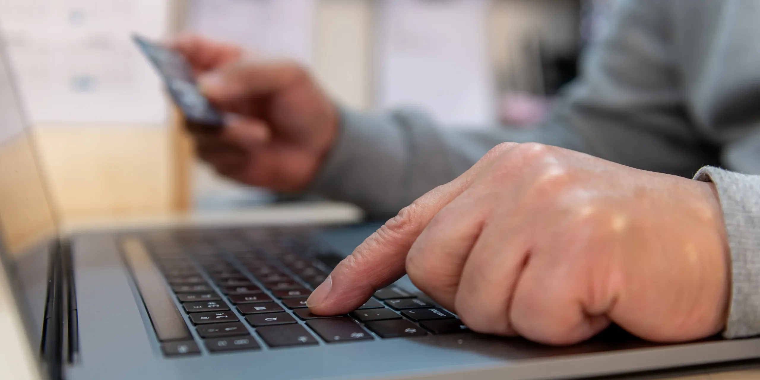 A person using a payment card to pay online.